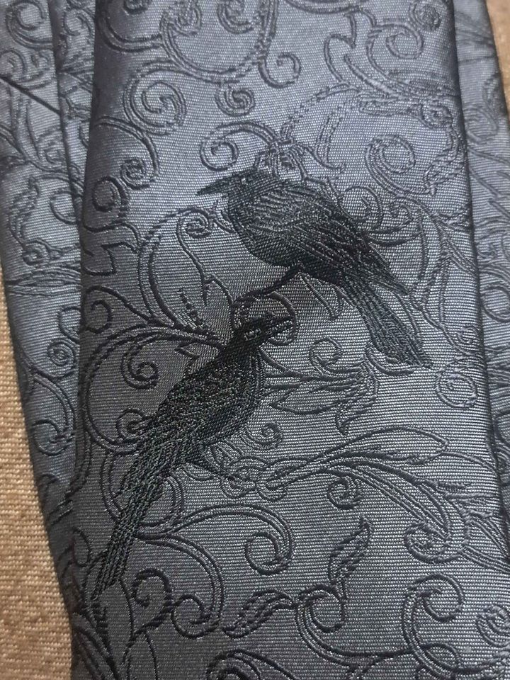 Close detail of ravens in the silk scroll pattern of The Odin